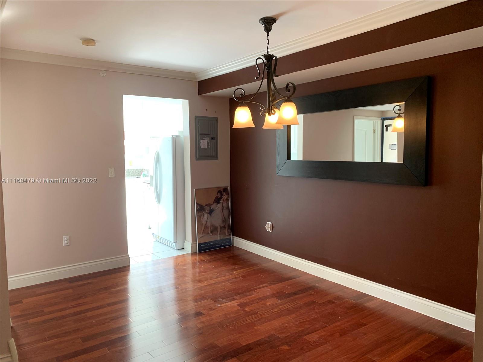 2501 Southwest 37th Avenue, Unit 306 Miami, FL 33133 - Photo 2 of 15 a view of empty room with wooden floor and fan