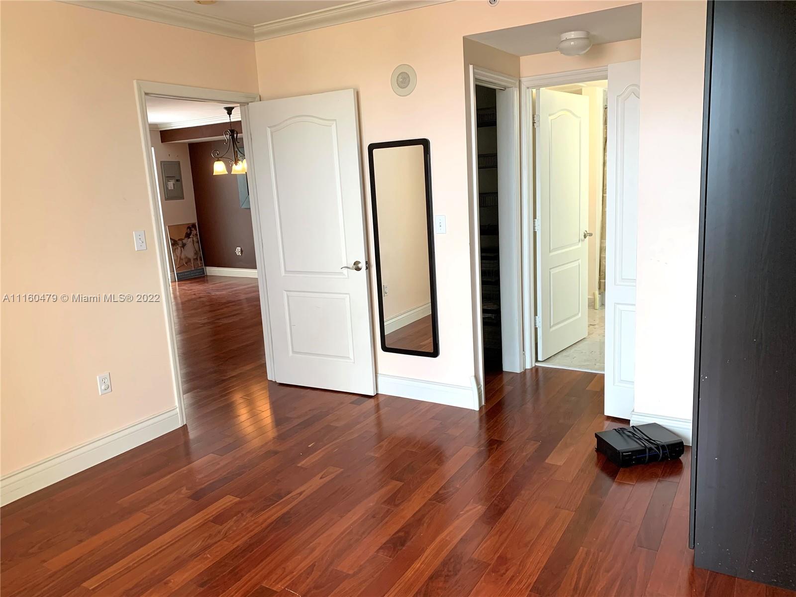 2501 Southwest 37th Avenue, Unit 306 Miami, FL 33133 - Photo 5 of 15 a view of a hallway with wooden floor