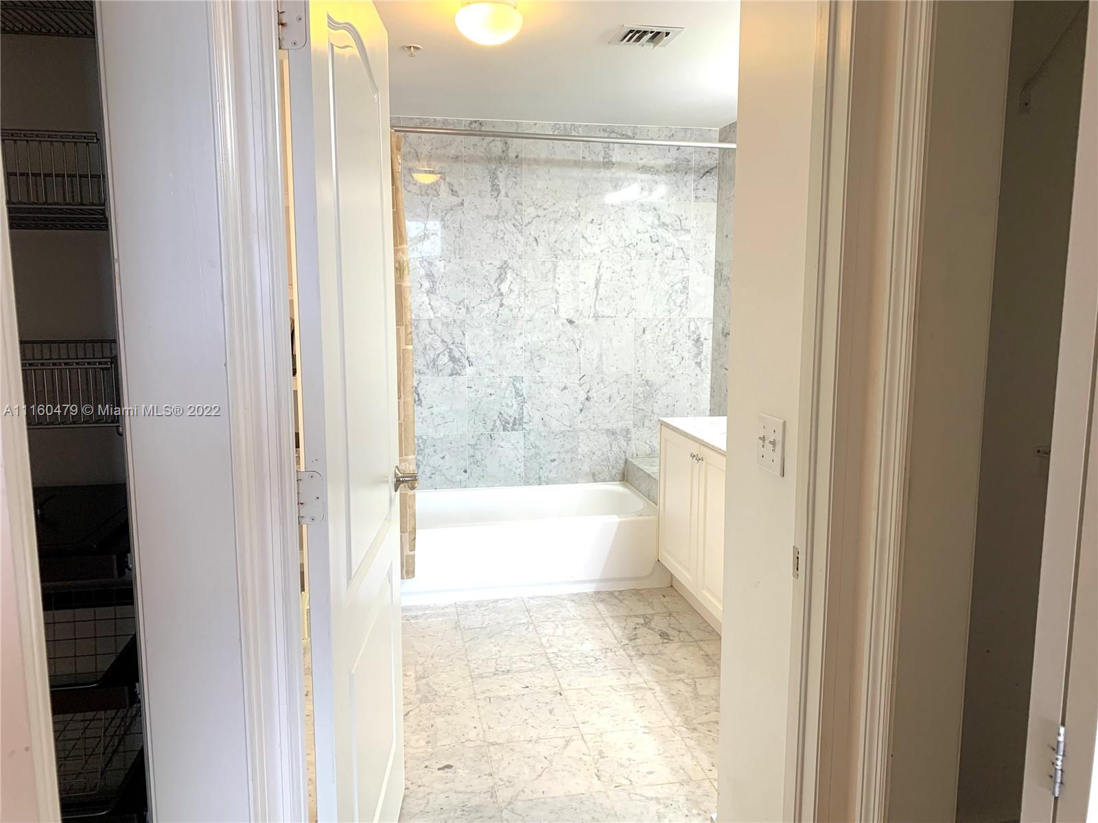 2501 Southwest 37th Avenue, Unit 306 Miami, FL 33133 - Photo 6 of 15 a bathroom with a bathtub and shower