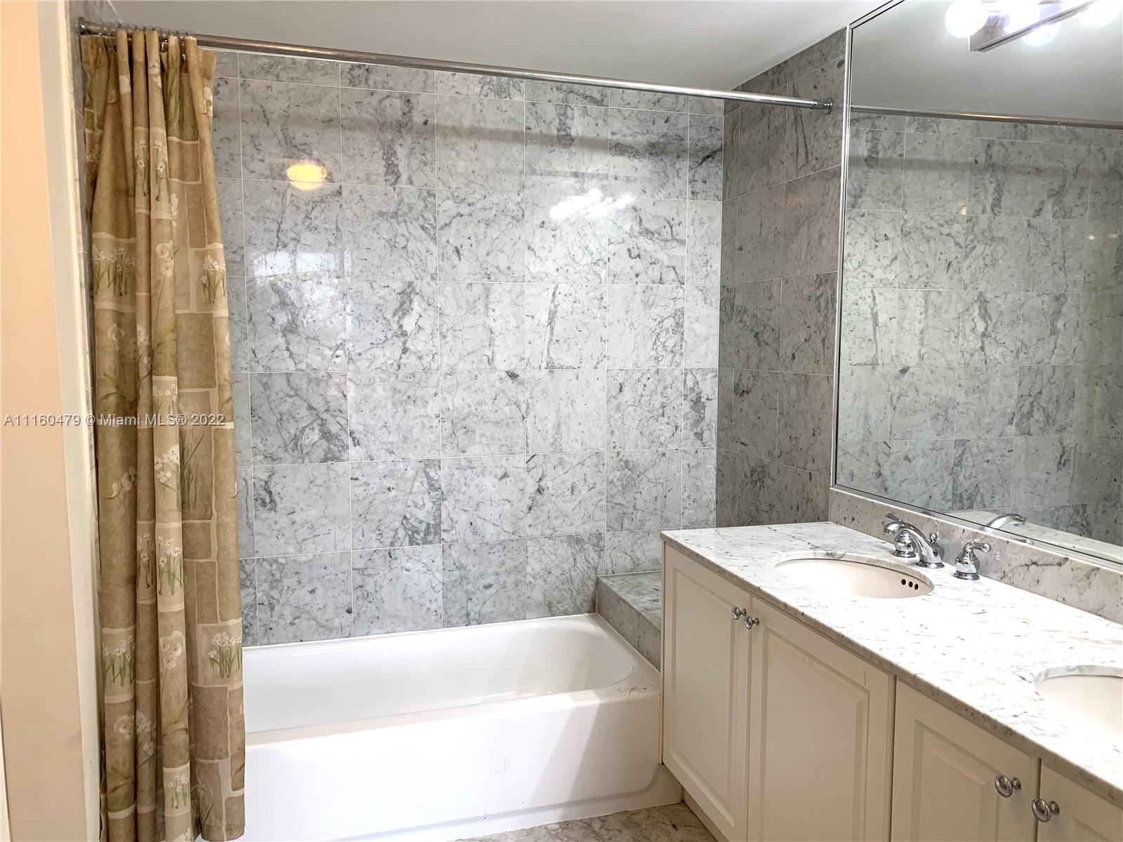 2501 Southwest 37th Avenue, Unit 306 Miami, FL 33133 - Photo 8 of 15 a bathroom with a shower and a sink