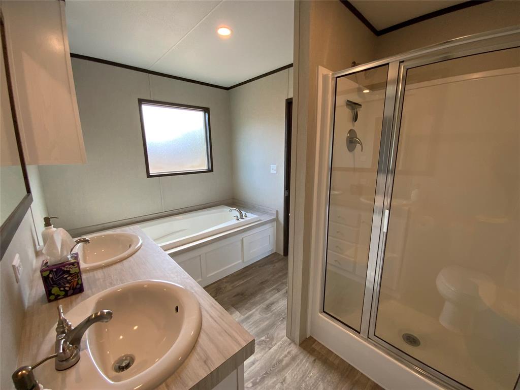 607 Faulkenberry Road Groesbeck, TX 76642 - Photo 26 of 40 a bathroom with a sink a toilet and shower