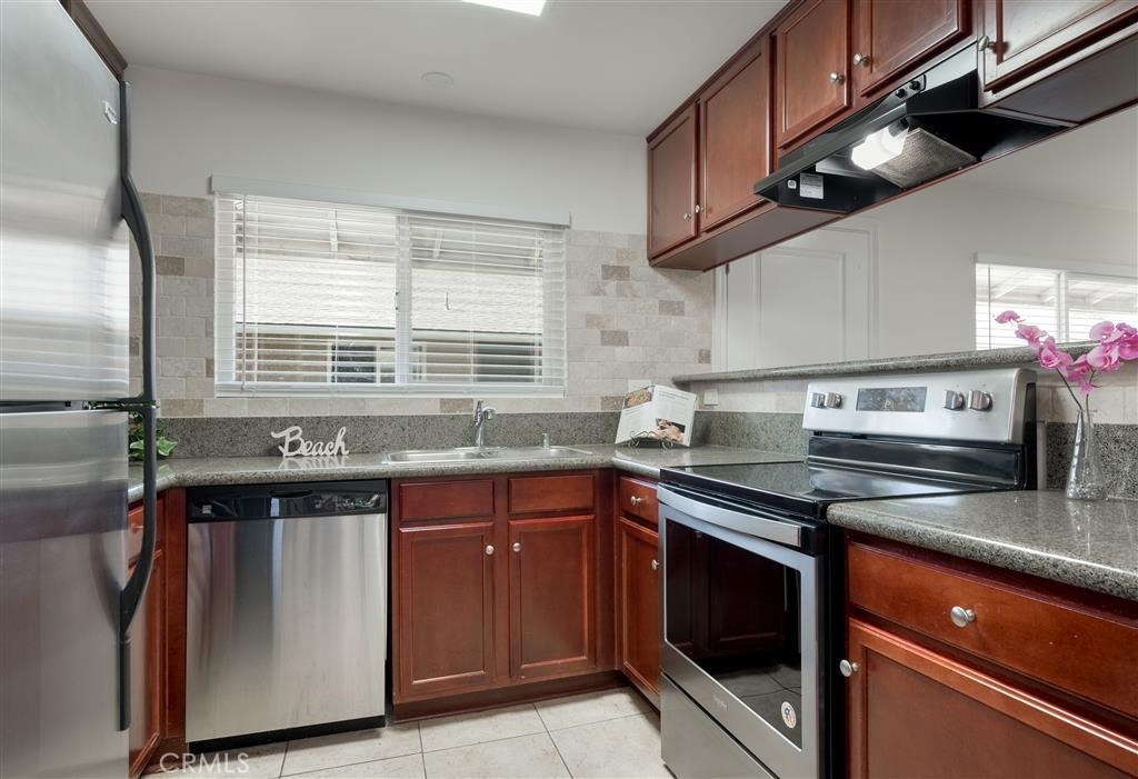 12805-18 Mapleview Street Lakeside, CA 92040 - Photo 8 of 28 a kitchen with stainless steel appliances granite countertop a sink and a stove