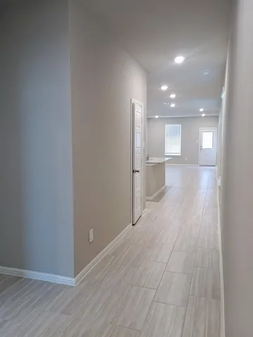 a view of a kitchen with a sink and wooden floor