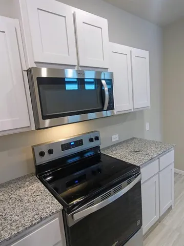 a stove top oven sitting inside of a kitchen