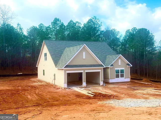 a view of a yard in front of a house with large trees