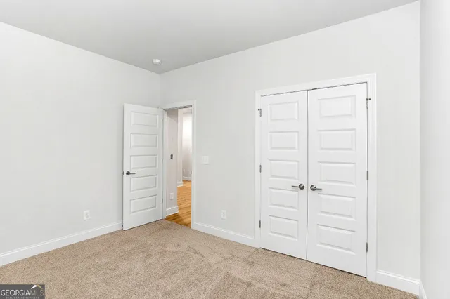 an empty room with closet area