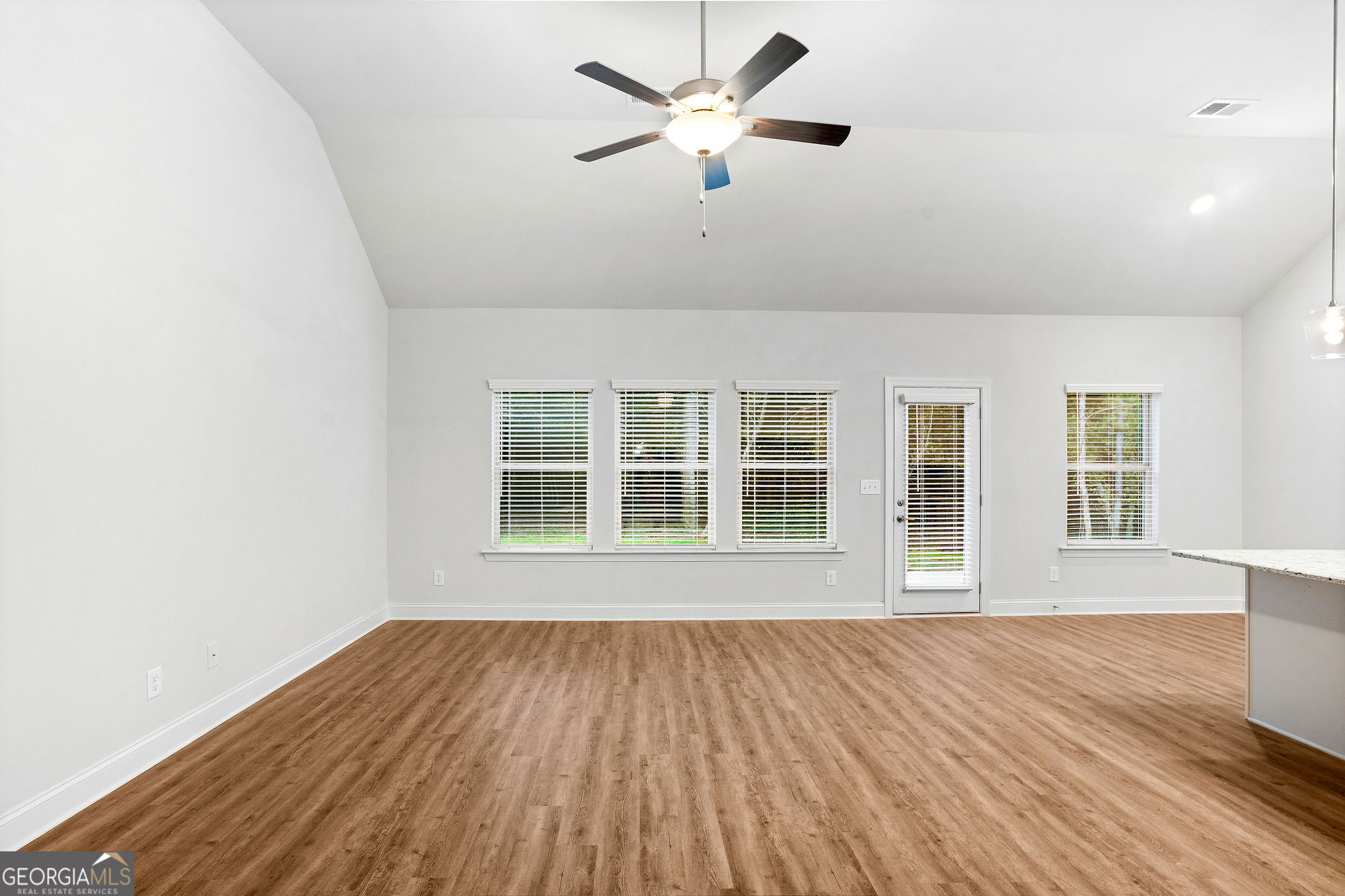 67 Sydney Court, Unit 44 Mansfield, GA 30055 - Photo 10 of 30 an empty room with wooden floor and windows