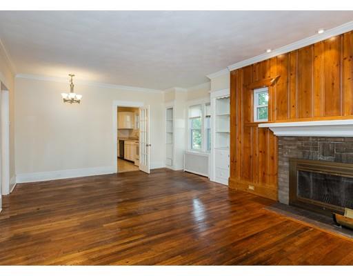 71 Marsden Street Springfield, MA 01109 - Photo 10 of 23 a view of an empty room with wooden floor fireplace and a window