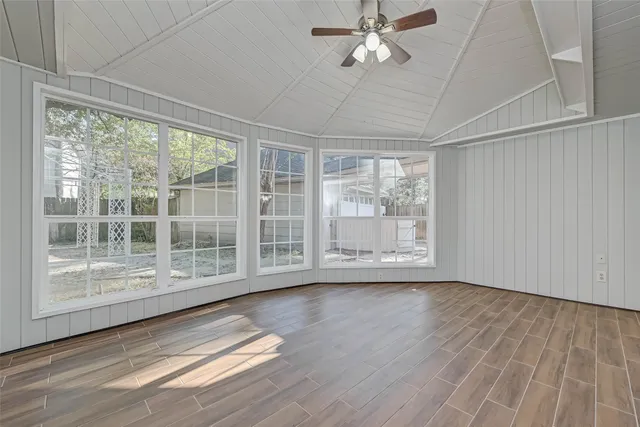 a view of a kitchen with cabinets and wooden floor