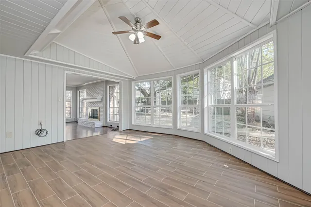 a white kitchen with a sink and wooden floor