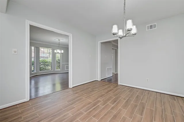 a kitchen with kitchen island granite countertop a sink cabinets and wooden floor