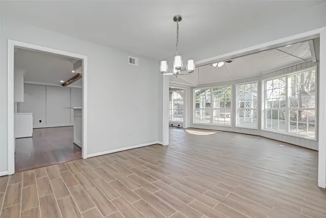 a kitchen with stainless steel appliances granite countertop a stove top oven a sink and white cabinets