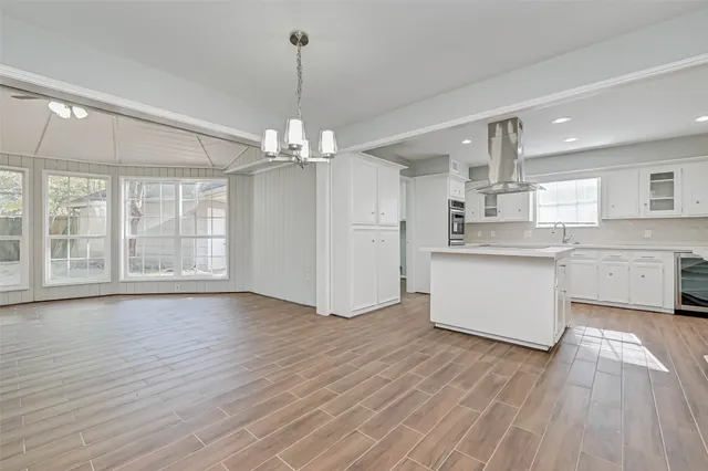 a view of kitchen with stainless steel appliances granite countertop a stove oven and a wooden floors