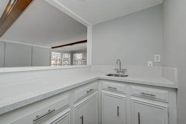 a kitchen with cabinets appliances wooden floor and a window
