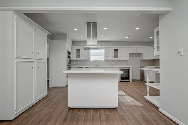 a view of a room with wooden floor and cabinet