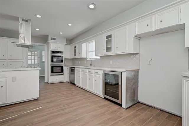 a bathroom with a toilet sink vanity and granite