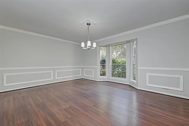 a view of a livingroom with wooden floor and a fireplace
