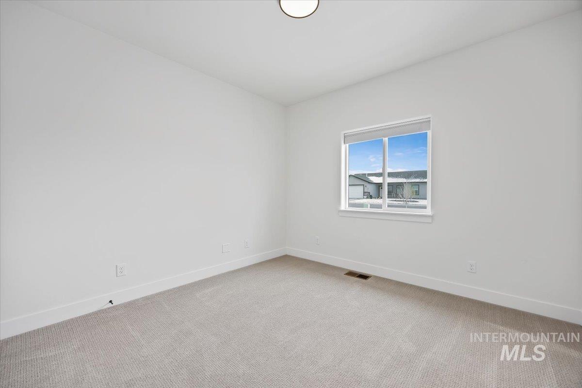 924 Trapper Peak Road Kimberly, ID 83341 - Photo 31 of 40 Unfurnished room with baseboards and light carpet