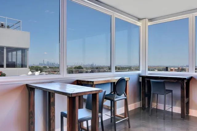 a dining table with chairs and a refrigerator