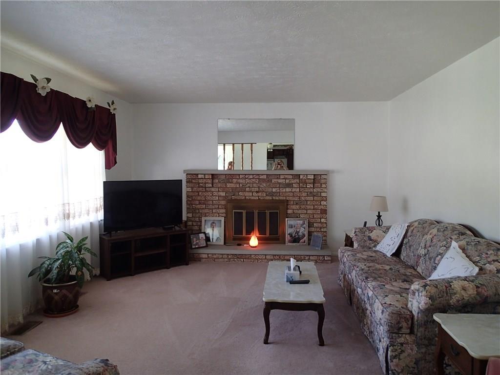 Spacious living room with large picture window that makes the room light and bright!
