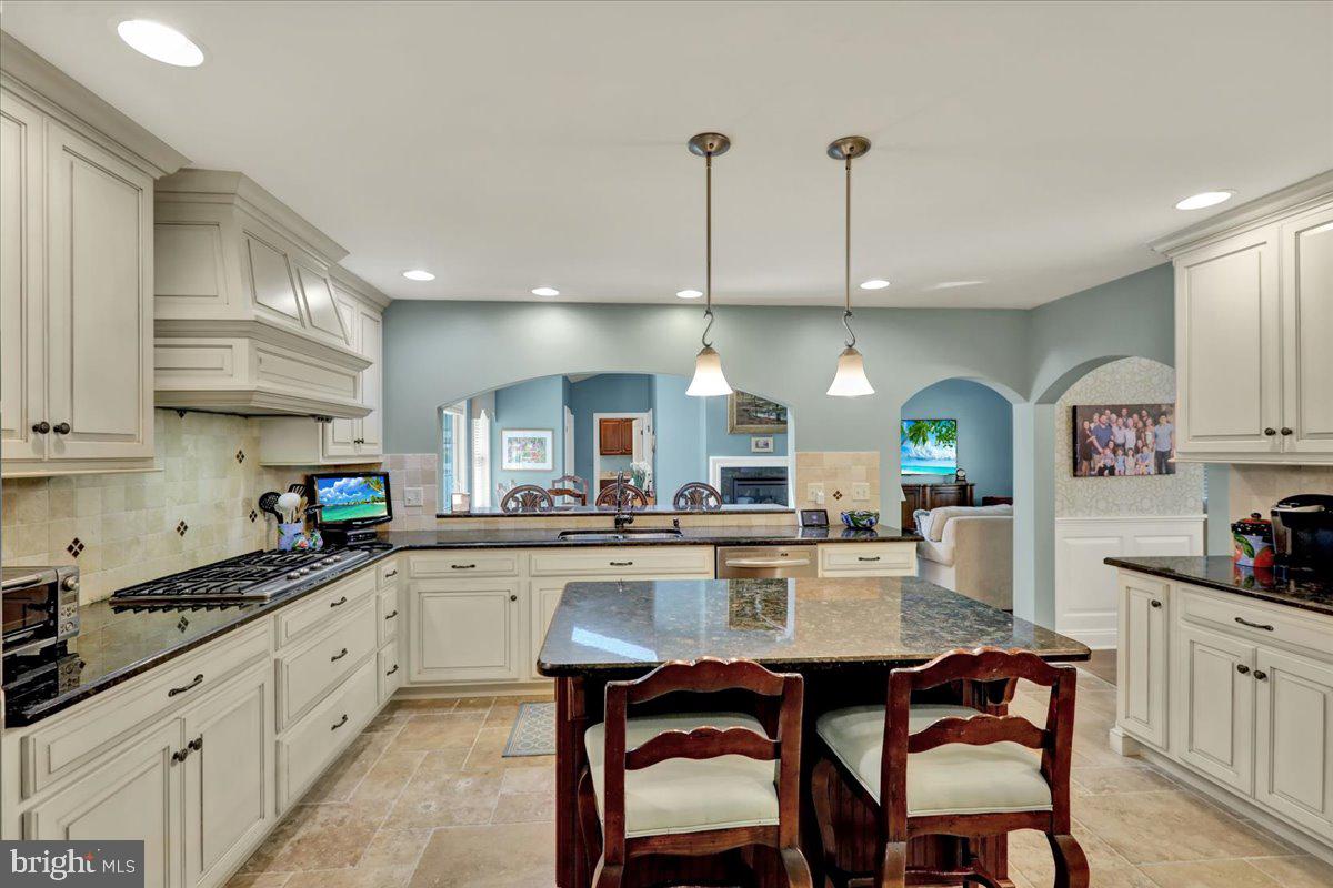 2 Cardinal Road Wyomissing, PA 19610 - Photo 13 of 51 a kitchen with stainless steel appliances a dining table chairs stove and cabinets