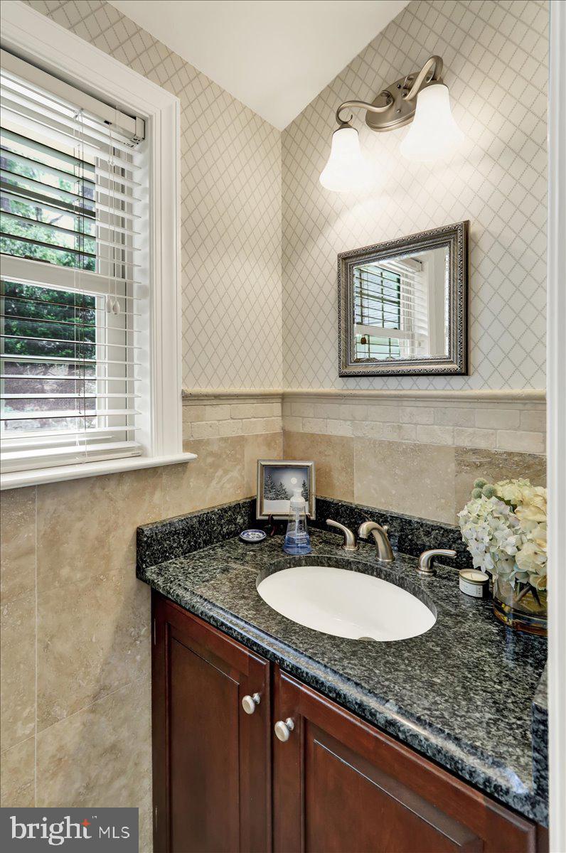 2 Cardinal Road Wyomissing, PA 19610 - Photo 26 of 51 a bathroom with a granite countertop sink and a mirror