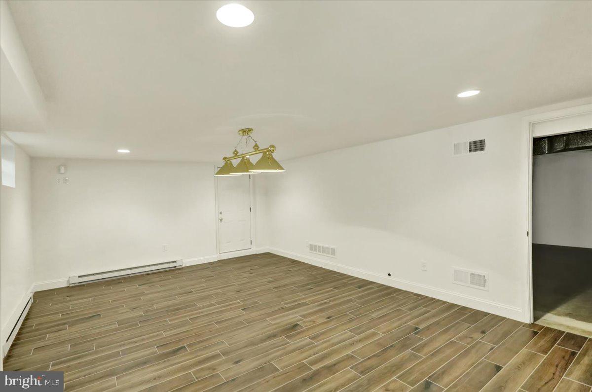 2 Cardinal Road Wyomissing, PA 19610 - Photo 44 of 51 an empty room with wooden floor and natural light