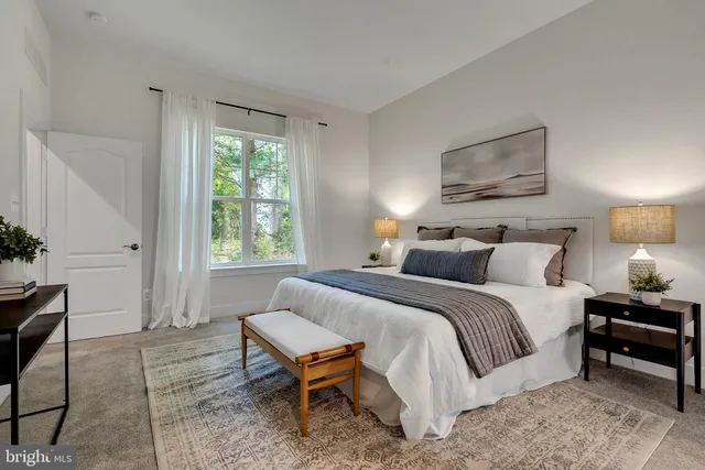 a bedroom with a bed a table and chair