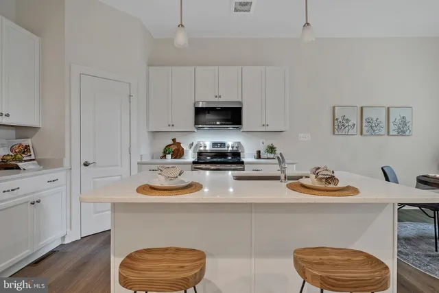 a kitchen with a sink and a stove top oven