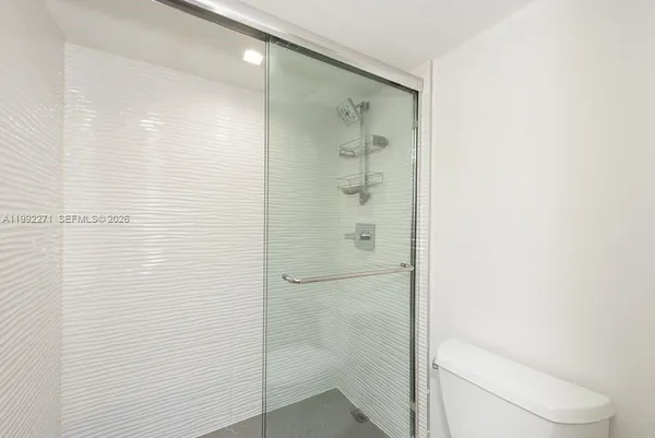 a bathroom with a shower and a toilet