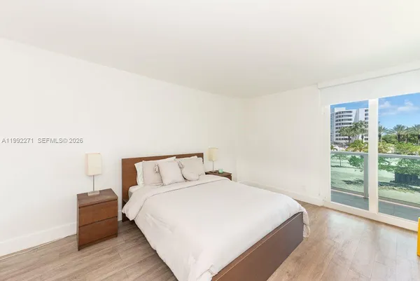 a bedroom with a bed and a large window