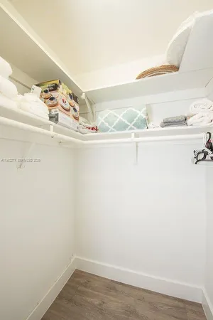 a view of a closet with wooden floor