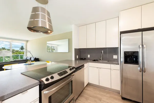 a kitchen with a stove a refrigerator and a sink