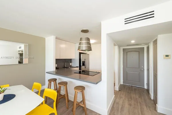 a dining room with furniture and wooden floor