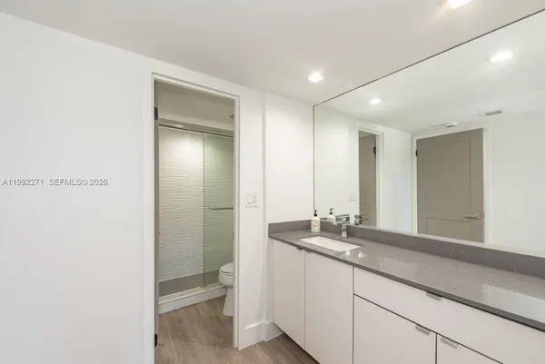 a bathroom with double vanity and a mirror