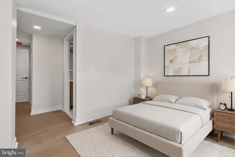 a bedroom with a bed and a painting on the wall