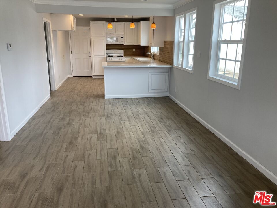 903 Arnold Drive Placentia, CA 92870 - Photo 2 of 11 a kitchen with stainless steel appliances wooden floors and granite counter tops