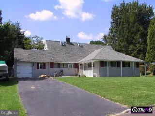 29 Fieldstone Road Levittown, PA 19056 - Photo 1 of 6 a front view of a house with a garden and trees