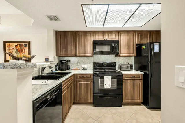 a kitchen with a sink stove and microwave