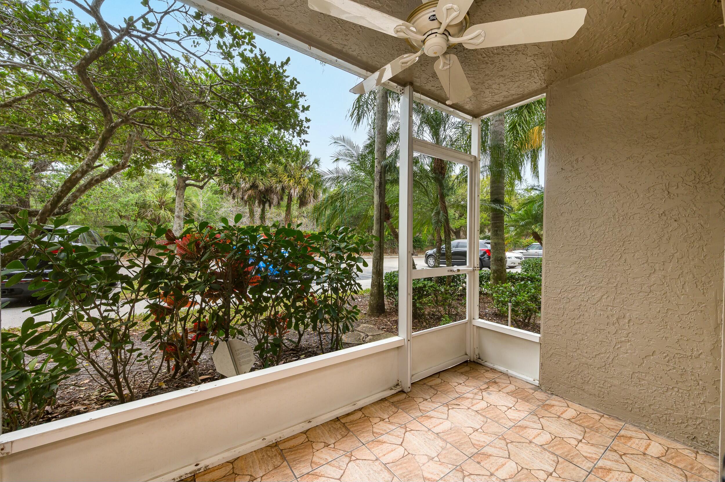 5031 Wiles Road, Unit 107 Coconut Creek, FL 33073 - Photo 19 of 22 a view of a glass door with a balcony