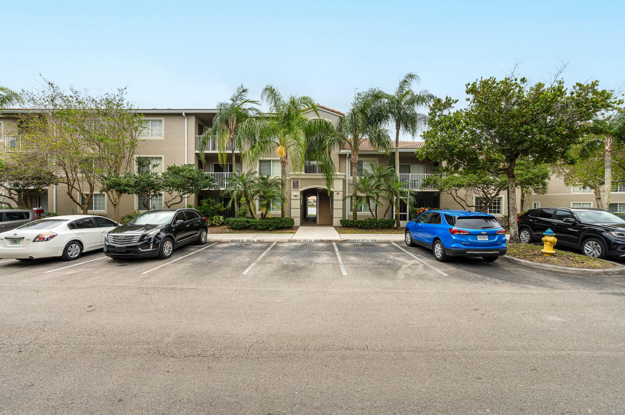 5031 Wiles Road, Unit 107 Coconut Creek, FL 33073 - Photo 20 of 22 a car parked in front of a house