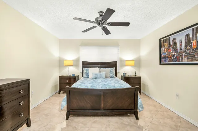 a bedroom with a bed and painting on the wall