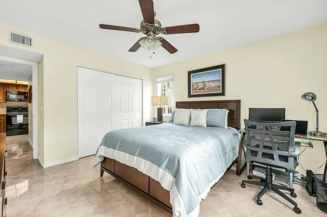 a bedroom with a bed and a chair