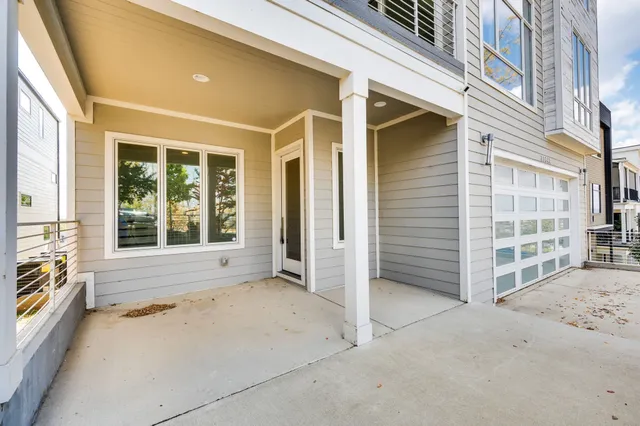 a view of a porch with a floor to ceiling window and wooden fence