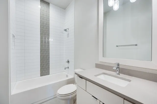 a white bath tub sitting next to a shower