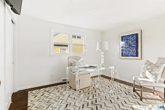 a room with a baby crib and a window