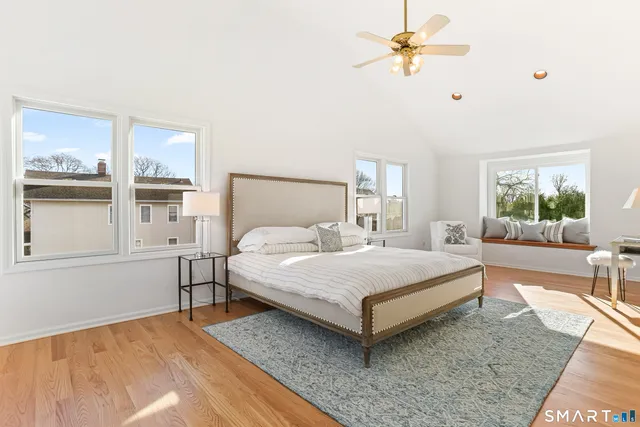 a bedroom with a bed chandelier and window