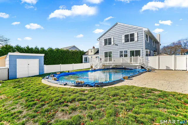 a swimming pool with outdoor seating and yard