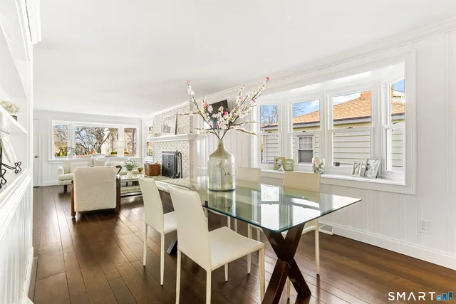 a view of a livingroom with furniture wooden floor and a large window