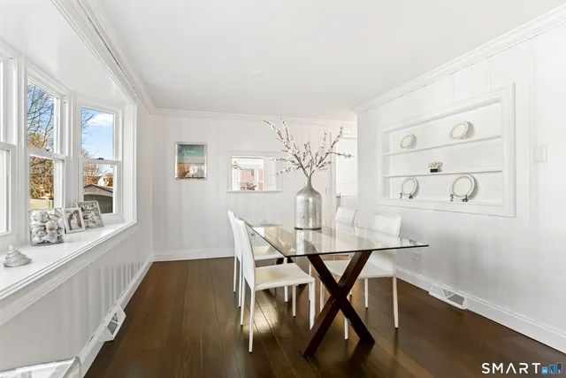 a view of a dining room with furniture and wooden floor
